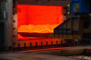 Forgings being removed from an industrial gas furnace