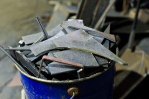 scrap metal in bucket in a forge