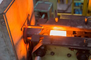 Preparing a preform in forging over an industrial induction furnace